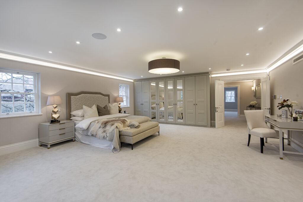 Bright bespoke bedroom with bed and wardrobe